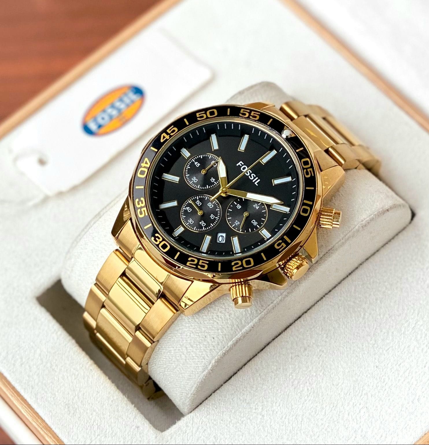 Fossil Bronson features a Black satin dial, chronograph movement and Two tone golden metal strap.