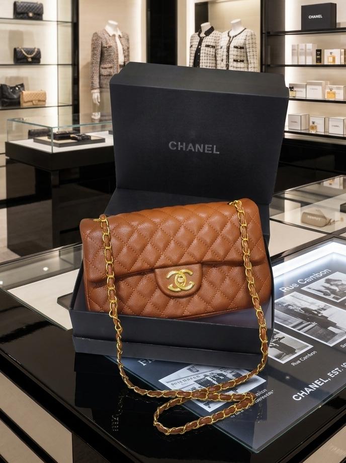 This is a brown quilted lambskin Chanel Classic 11.12 handbag featuring a gold-tone turnlock clasp.